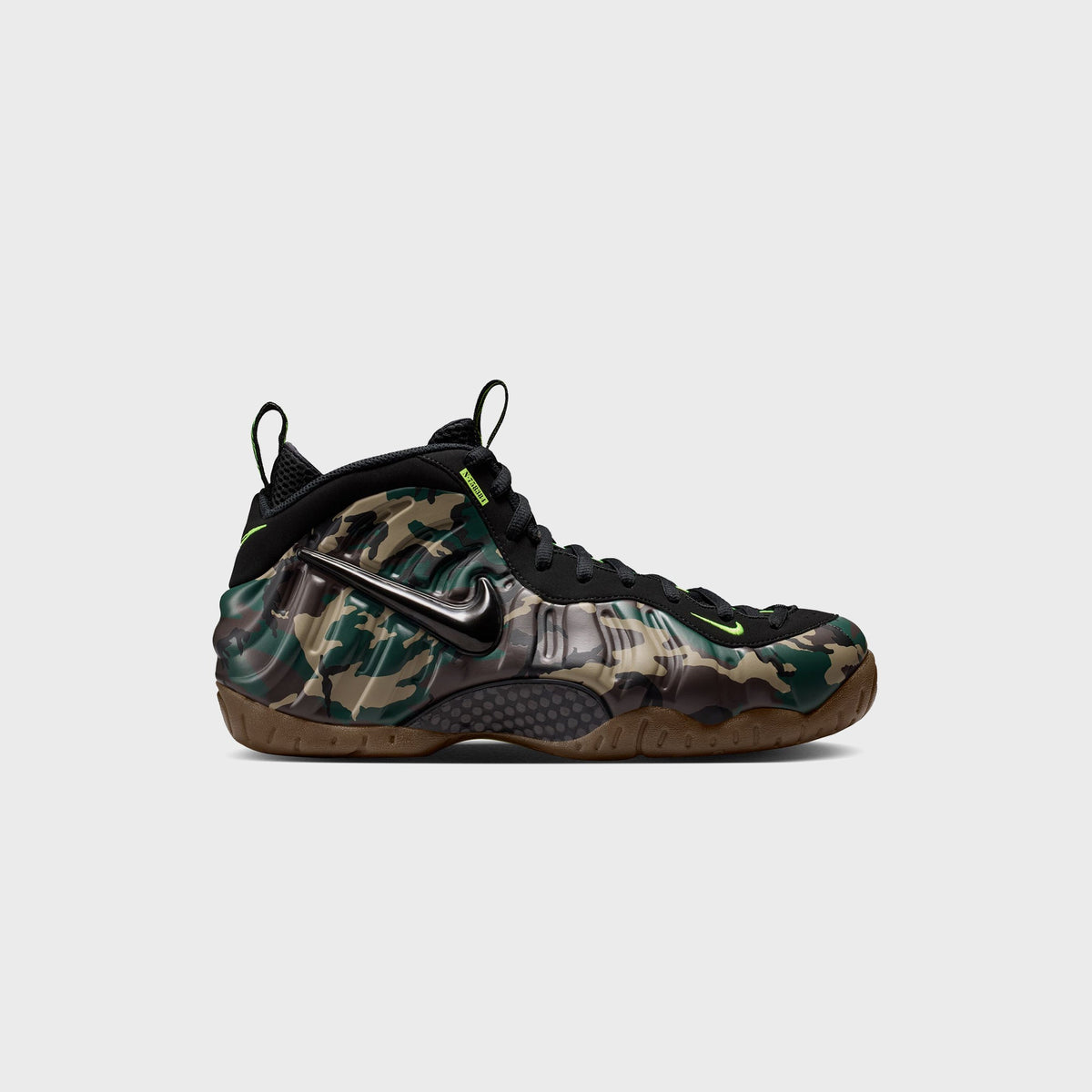 Nike Air Foamposite Pro sneaker in army green camo with black upper, volt green Swoosh and gum sole, side profile