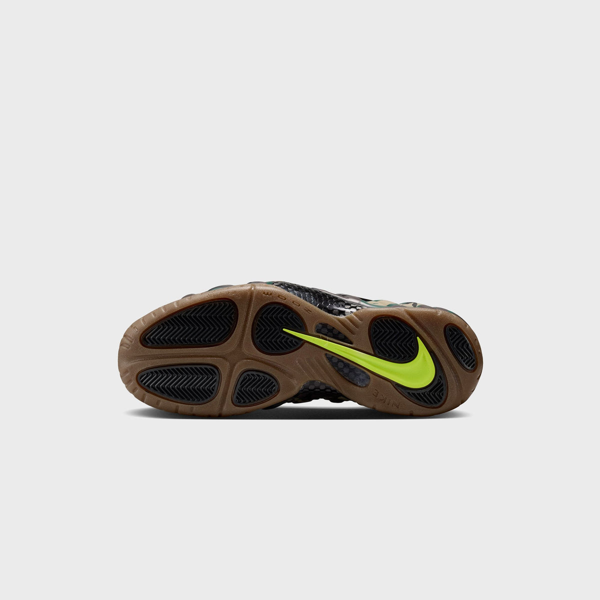 Gum outsole of Nike Air Foamposite Pro with volt green Swoosh and Zoom Air branding