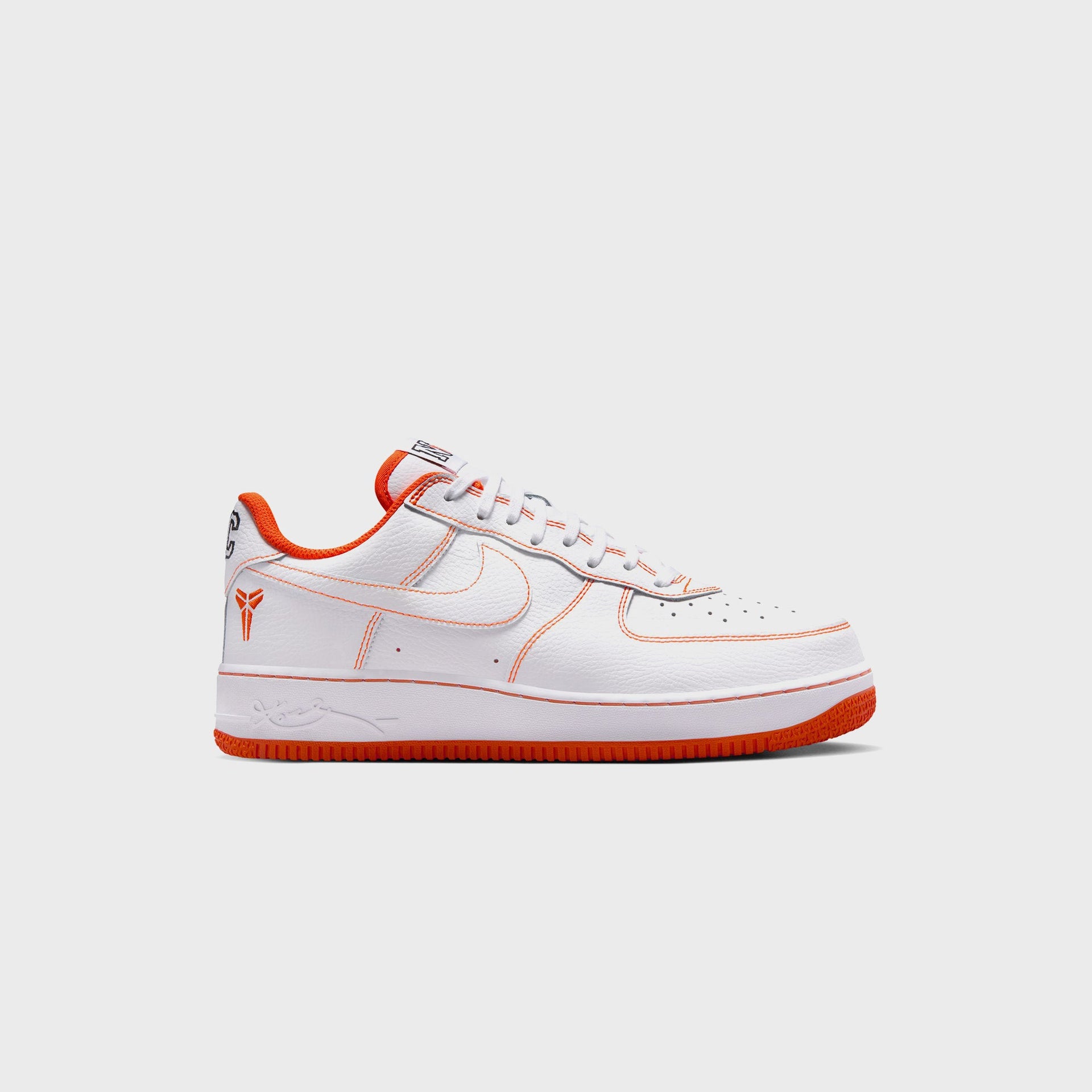Nike Air Force 1 Low Protro NYC in white leather, lateral profile with safety orange stitching, Kobe sheath logo and orange sole