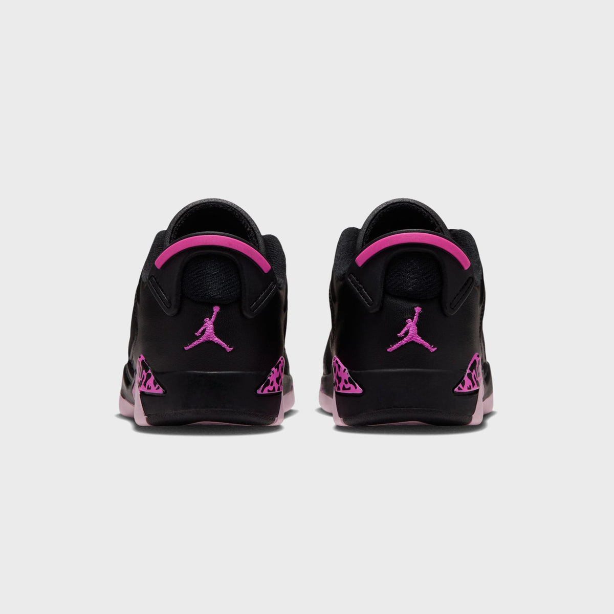 Rear view of black Air Jordan 6 Retro Low PS pair showing pink heel tabs, pink Jumpman logos and leopard-print accents