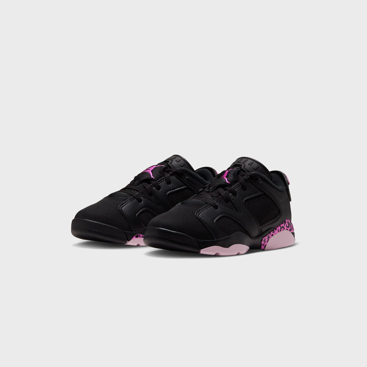 Pair of Jordan PS Air Jordan 6 Retro Low black sneakers with pink Jumpman logos and leopard heel, three-quarter angle