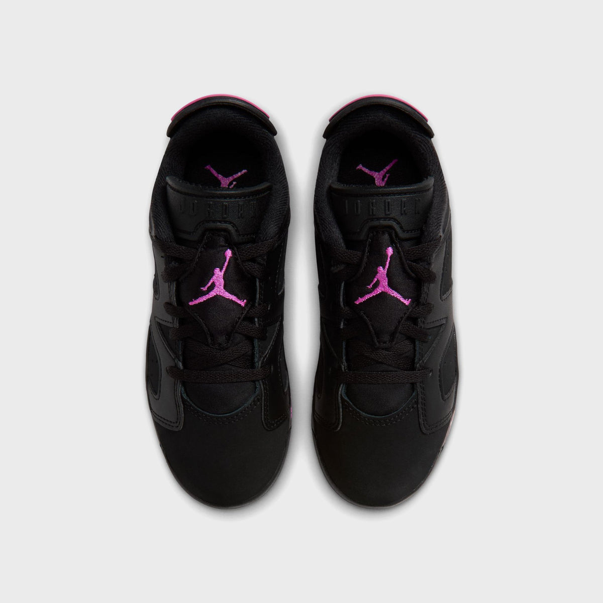 Top-down view of black Air Jordan 6 Retro Low PS pair with pink Jumpman logos on tongues and black laces