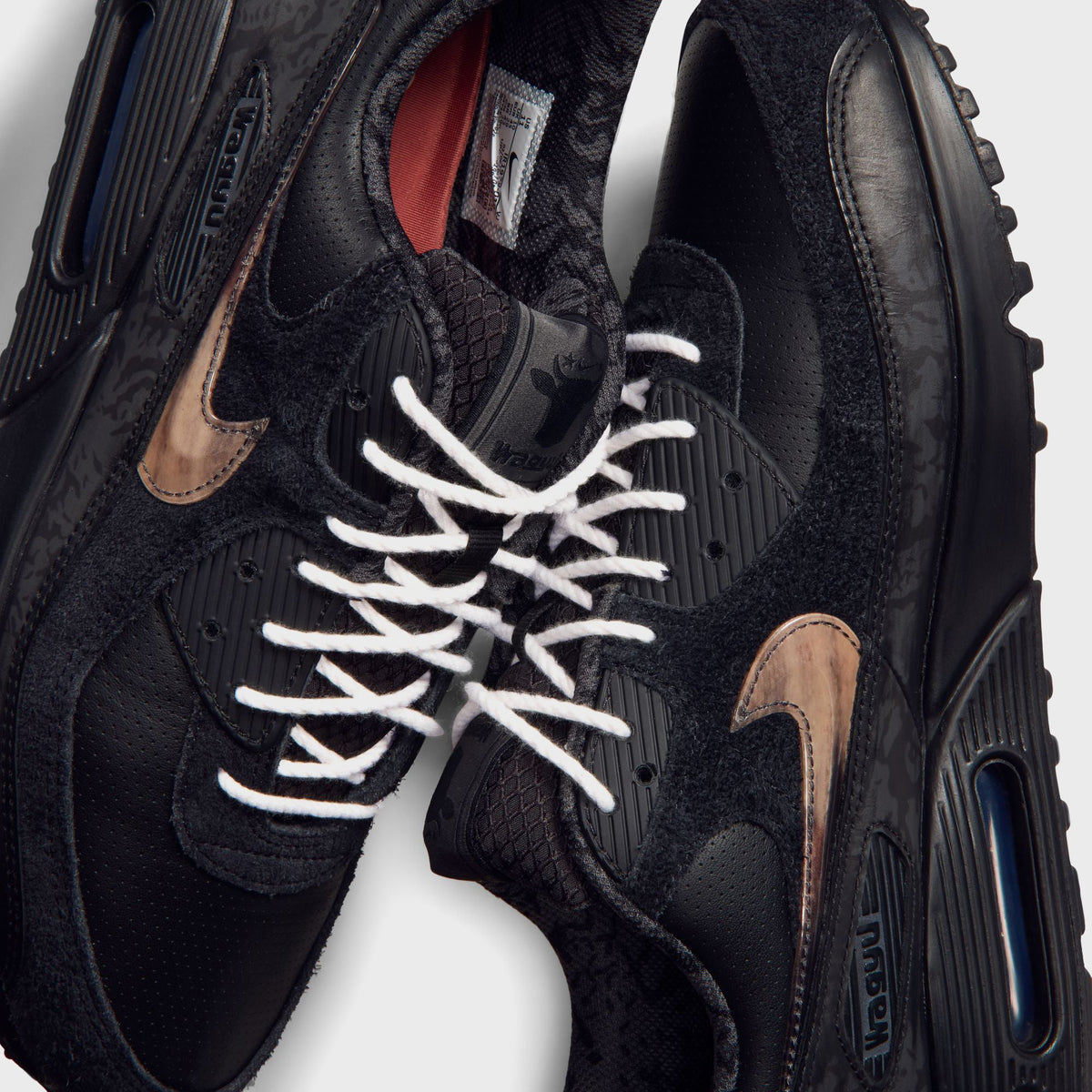 Close-up of Nike x Wagyu Air Max 90 tongue showing marbled amber swoosh and Wagyu ankle branding
