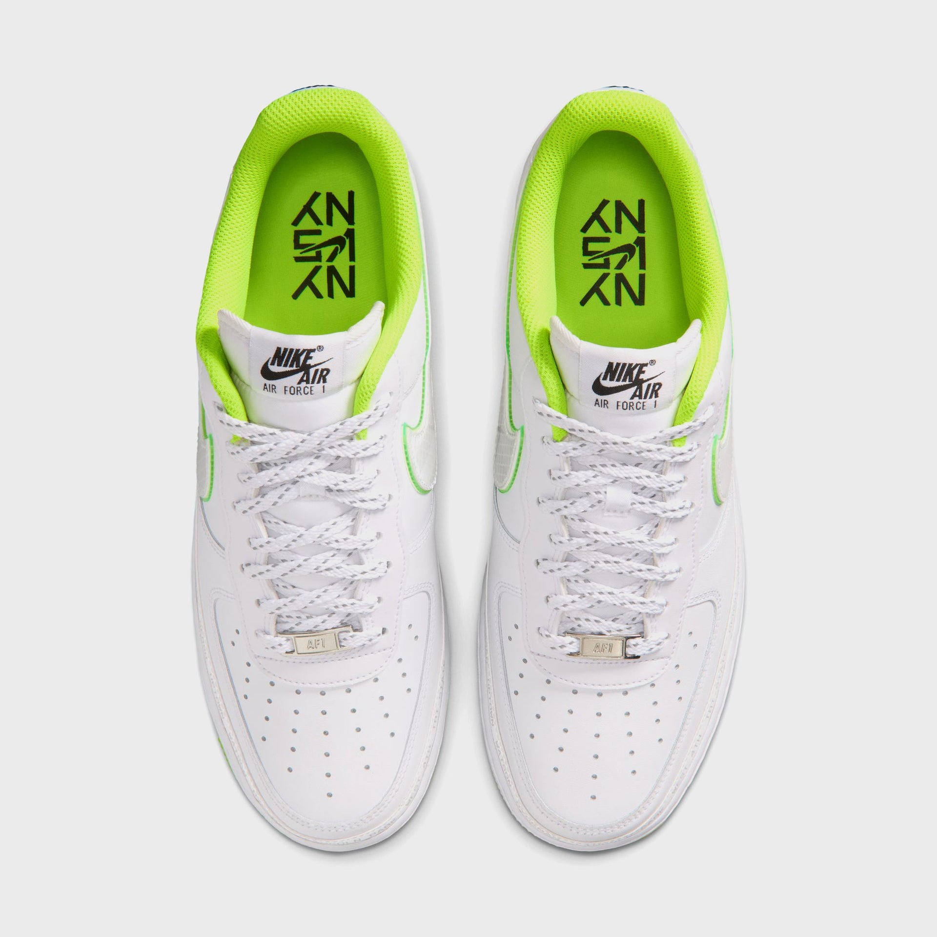 Nike Air Force 1 '07 pair from above: white uppers, volt lining, silver AF1 lace dubraes and a black NY vs NY insole graphic
