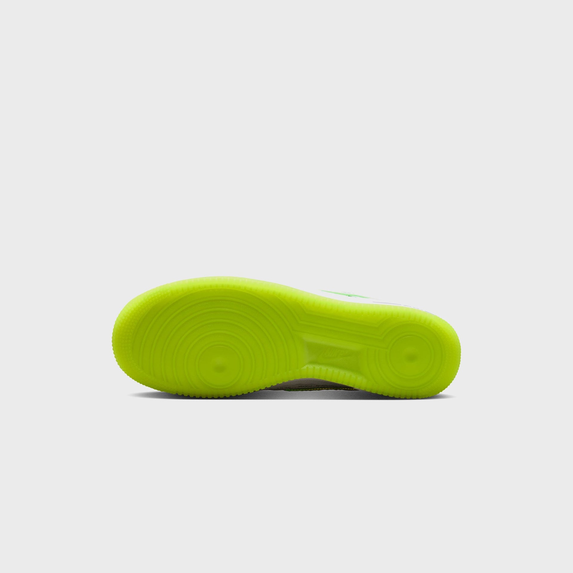 Nike Air Force 1 '07 bottom view: translucent volt-green AF1 pivot-circle outsole with embossed Nike Air branding