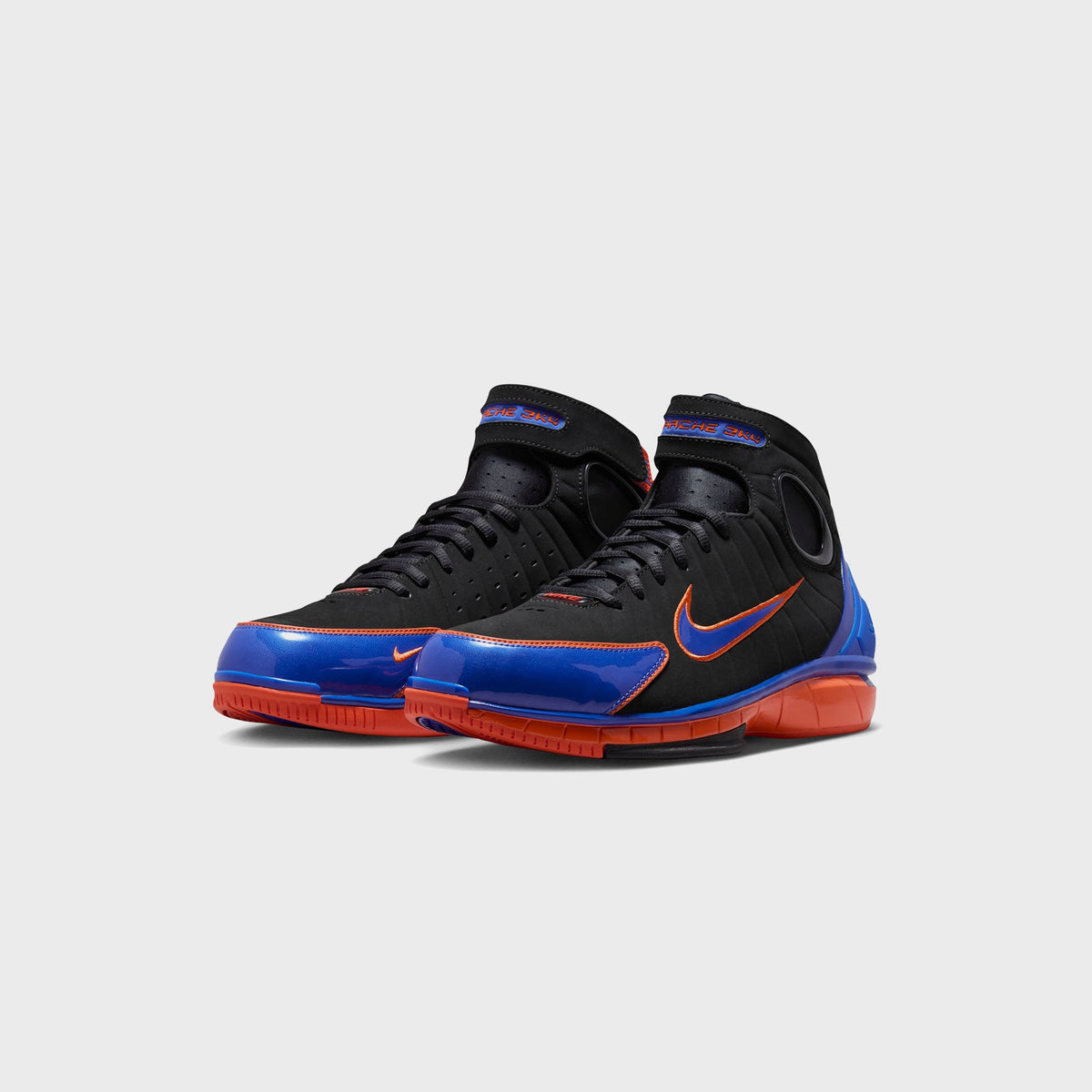 Nike Air Zoom Huarache 2K4 basketball shoes in Black, Varsity Royal, and Safety Orange, front three-quarter view of the pair