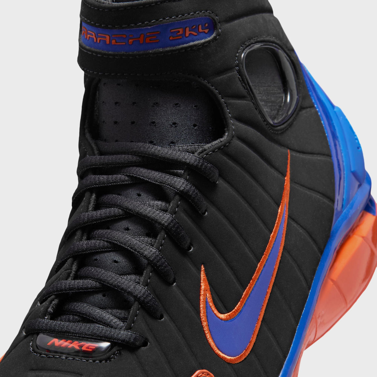Nike Air Zoom Huarache 2K4 basketball shoe, close-up of the Varsity Royal Swoosh on the black quilted toe box