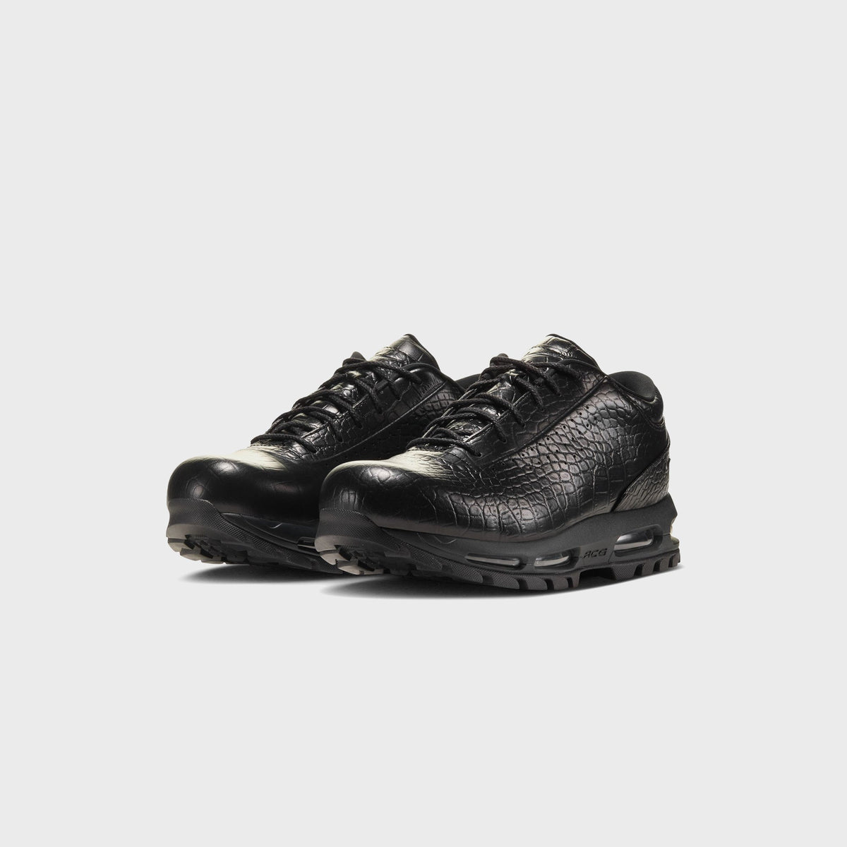 Nike Air Max Goadome Low black, three-quarter front view of pair with croc-textured leather and chunky sole