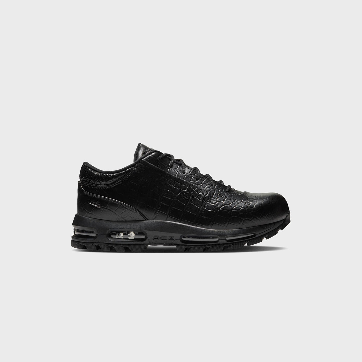 Nike Air Max Goadome Low in black croc-embossed leather, side profile with visible Air unit and lugged outsole