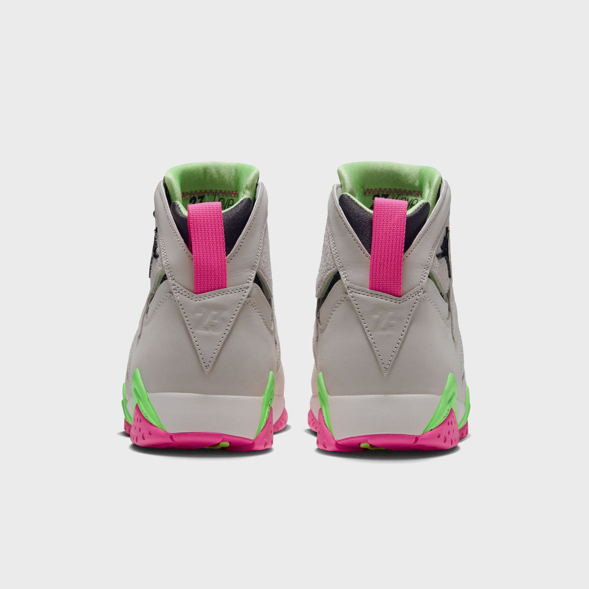 Back view of Air Jordan 7 Phantom Lime Blast sneakers highlighting pink pull tabs and green heel accents