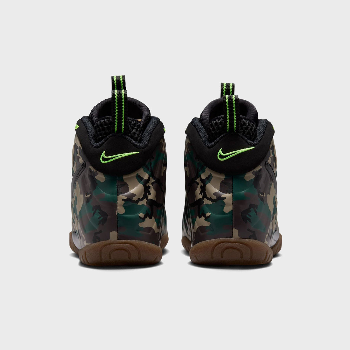 Close-up of Nike PS Little Posite Pro toe featuring glossy black Swoosh on camo foam shell