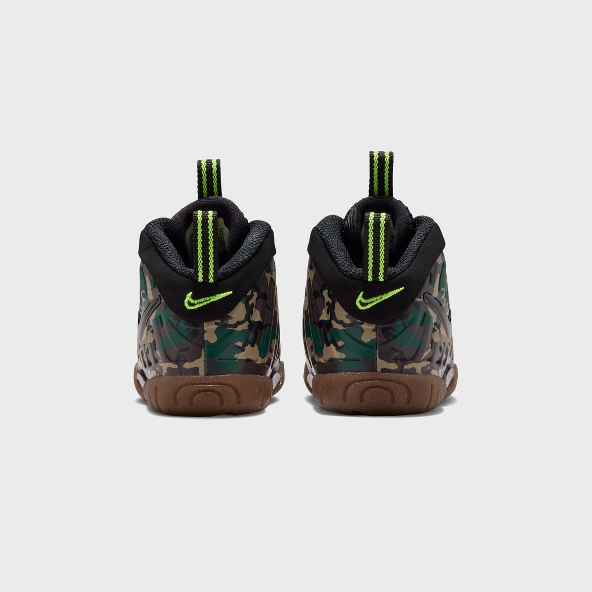 Close-up of Nike TD Little Posite Pro toddler sneaker toe with glossy black Swoosh on camo foam
