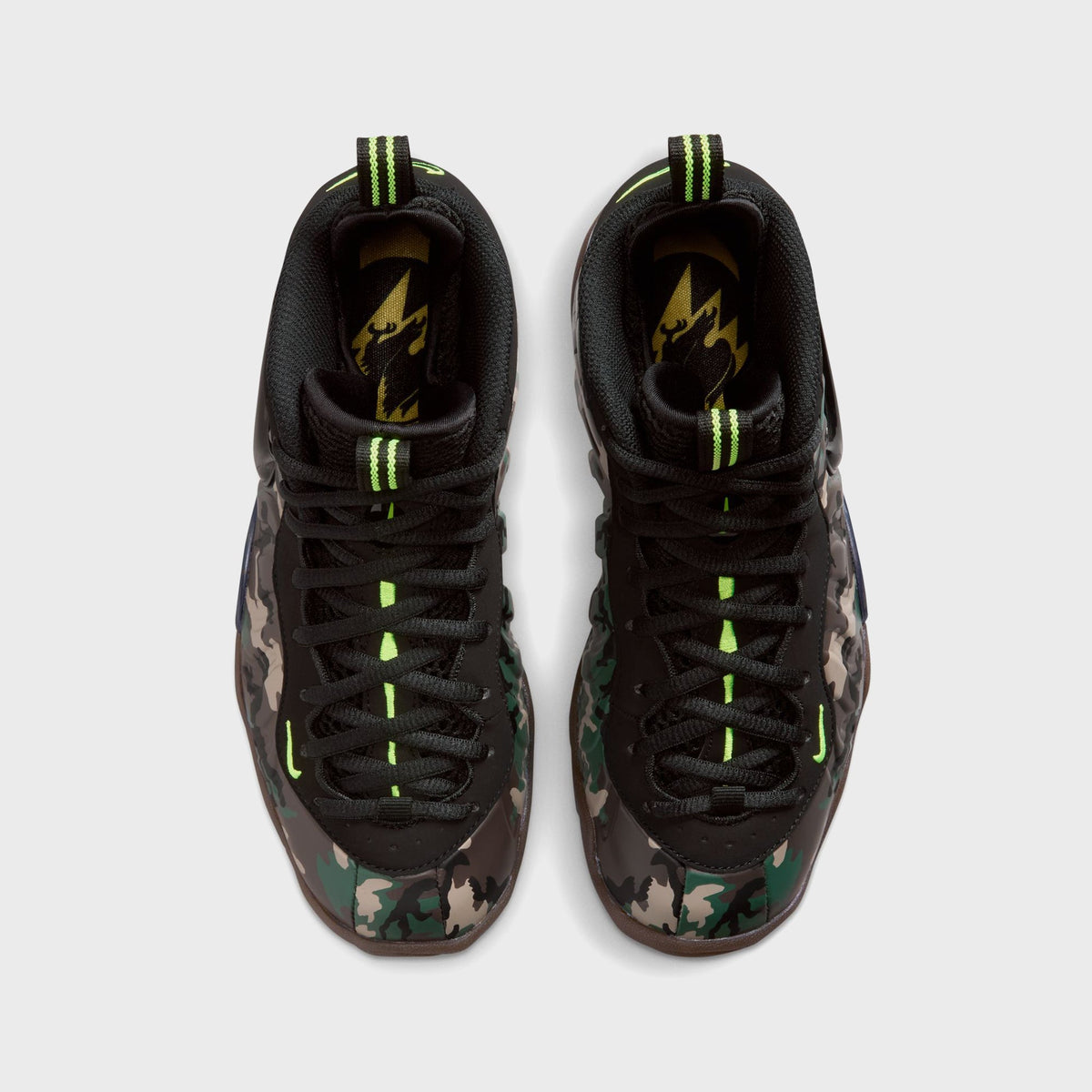 Top-down view of Nike GS Little Posite Pro sneakers showing black laces and volt green pull tabs