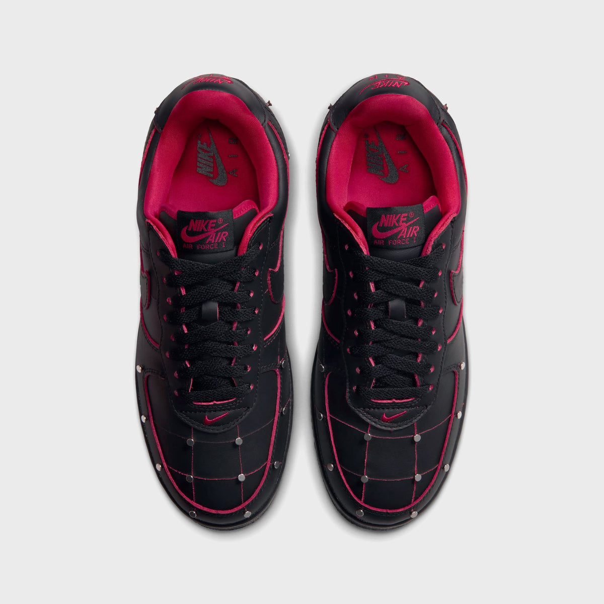 Top-down view of black Nike Air Force 1 '01 sneakers with red stitching and silver studs