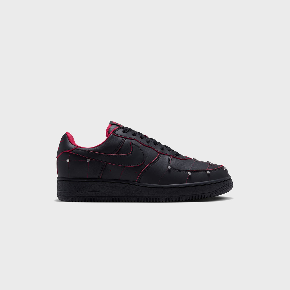 Nike Air Force 1 '01 in black leather with red stitching and silver studs, lateral side view