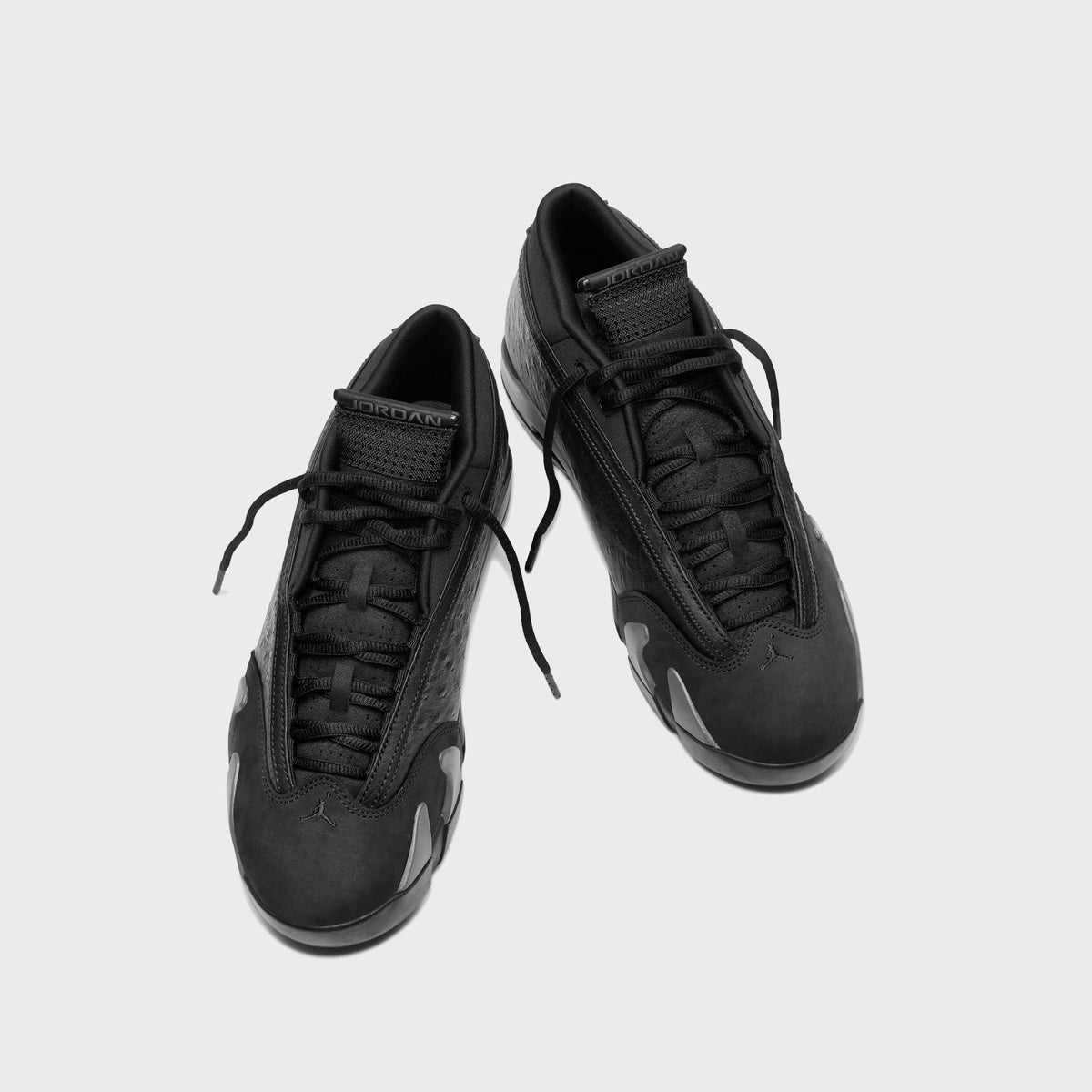 Air Jordan 14 Low Black / Off Noir pair, top-down view of black laces, JORDAN tongue label and suede toe