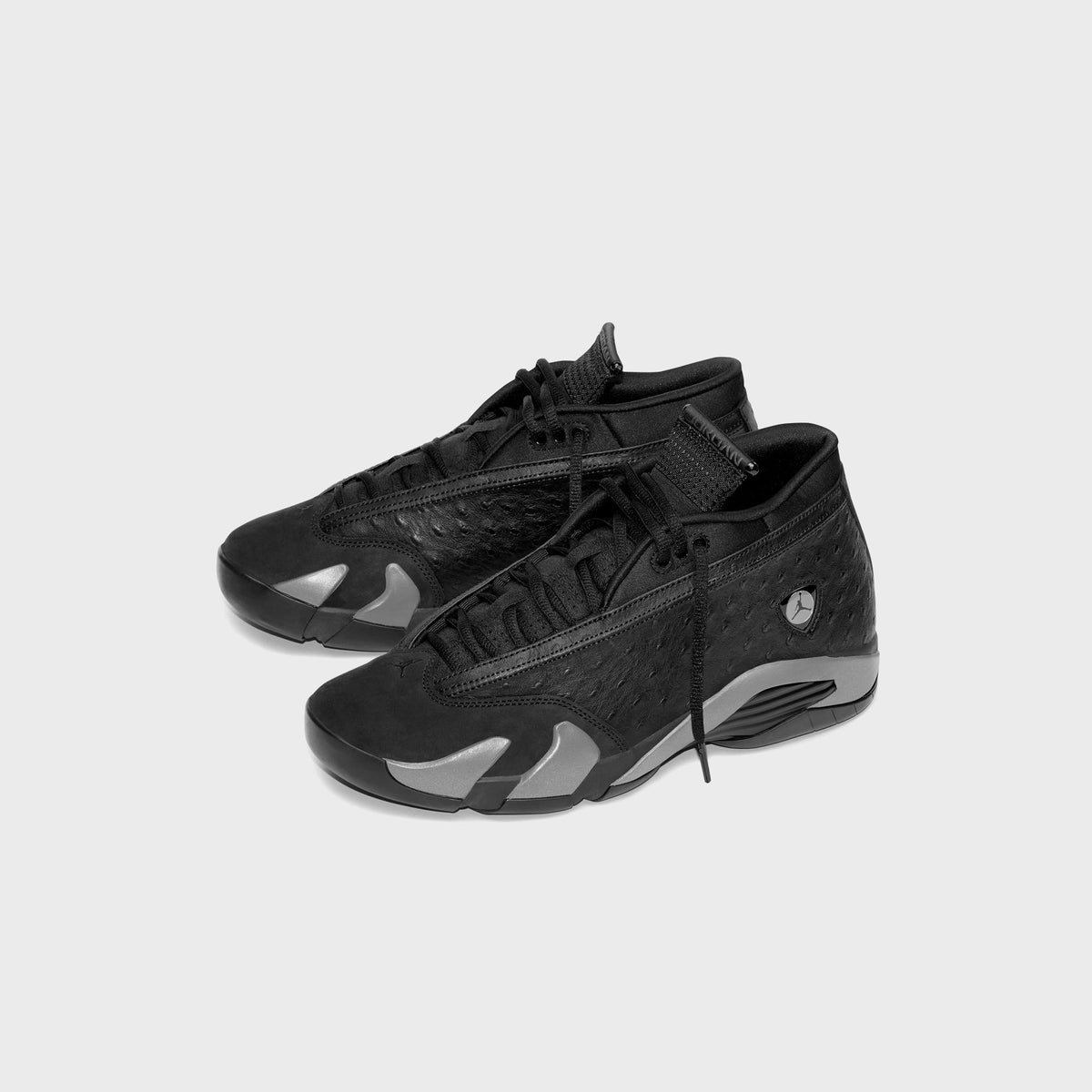 Pair of Air Jordan 14 Low sneakers in black, three-quarter angle showing black laces and grey outsole accents