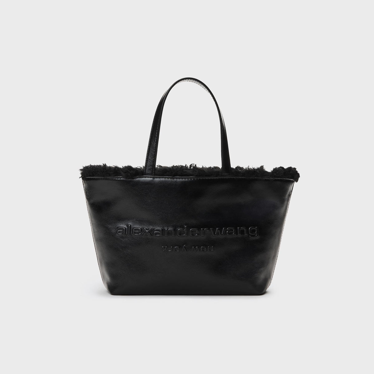 Alexander Wang Punch Small Tote Bag in Black, black leather tote with detachable strap and embossed logo, front view