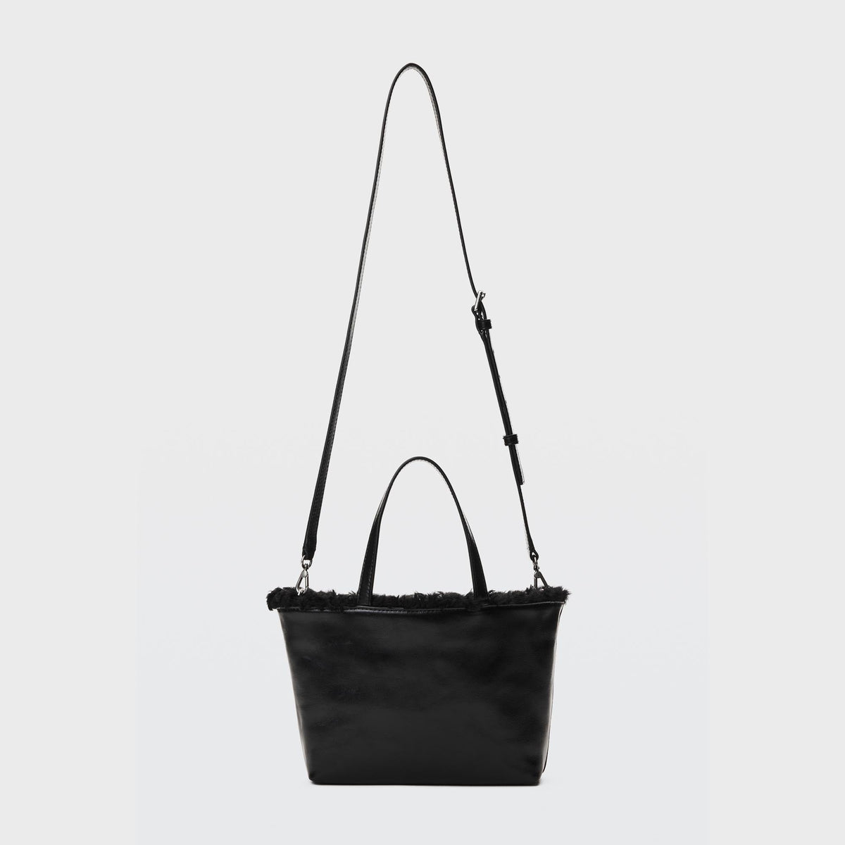 Alexander Wang Punch Small Tote Bag in Black, shown with the detachable crossbody strap attached