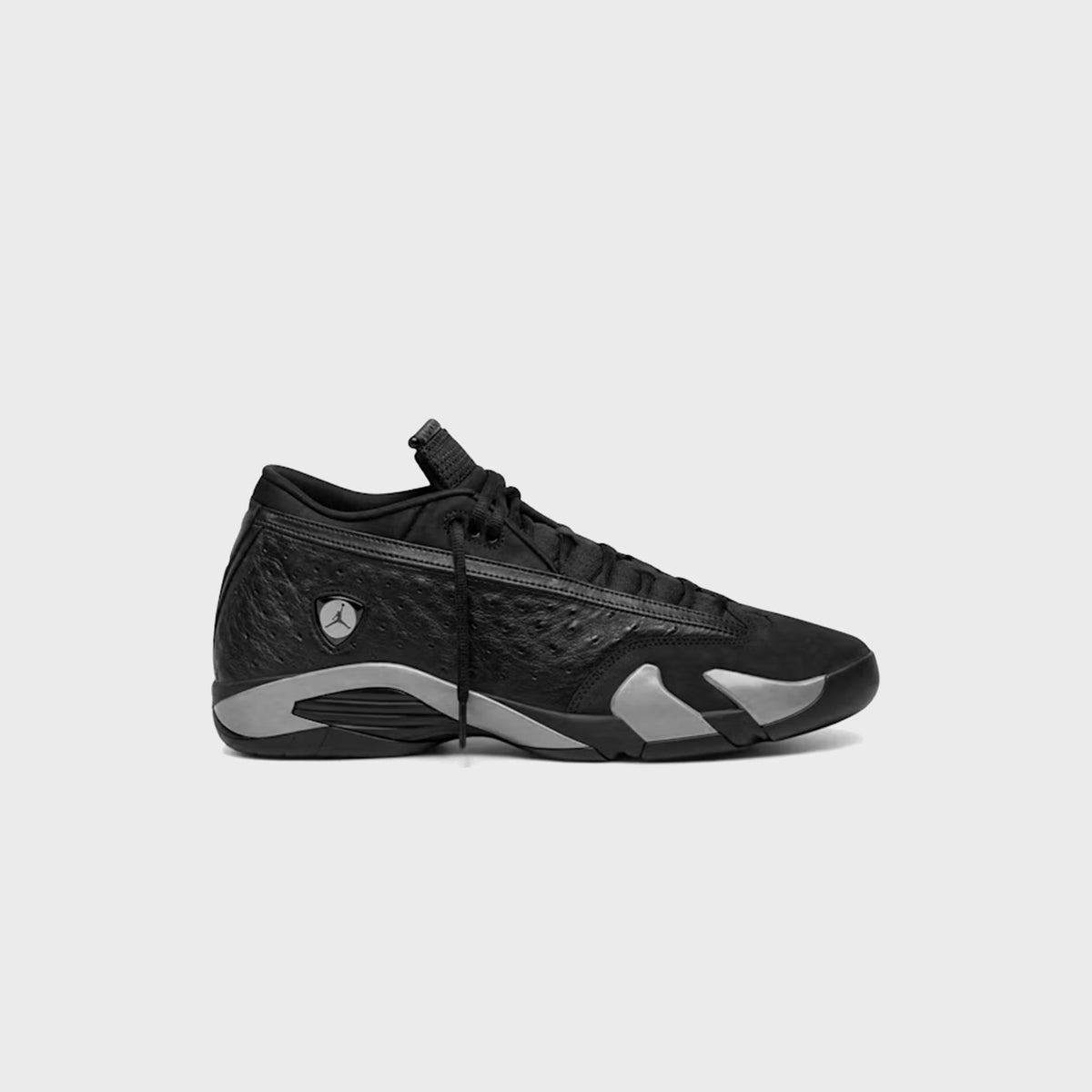 Air Jordan 14 Low in black ostrich-textured leather and suede with grey outsole panels, side profile, lateral view