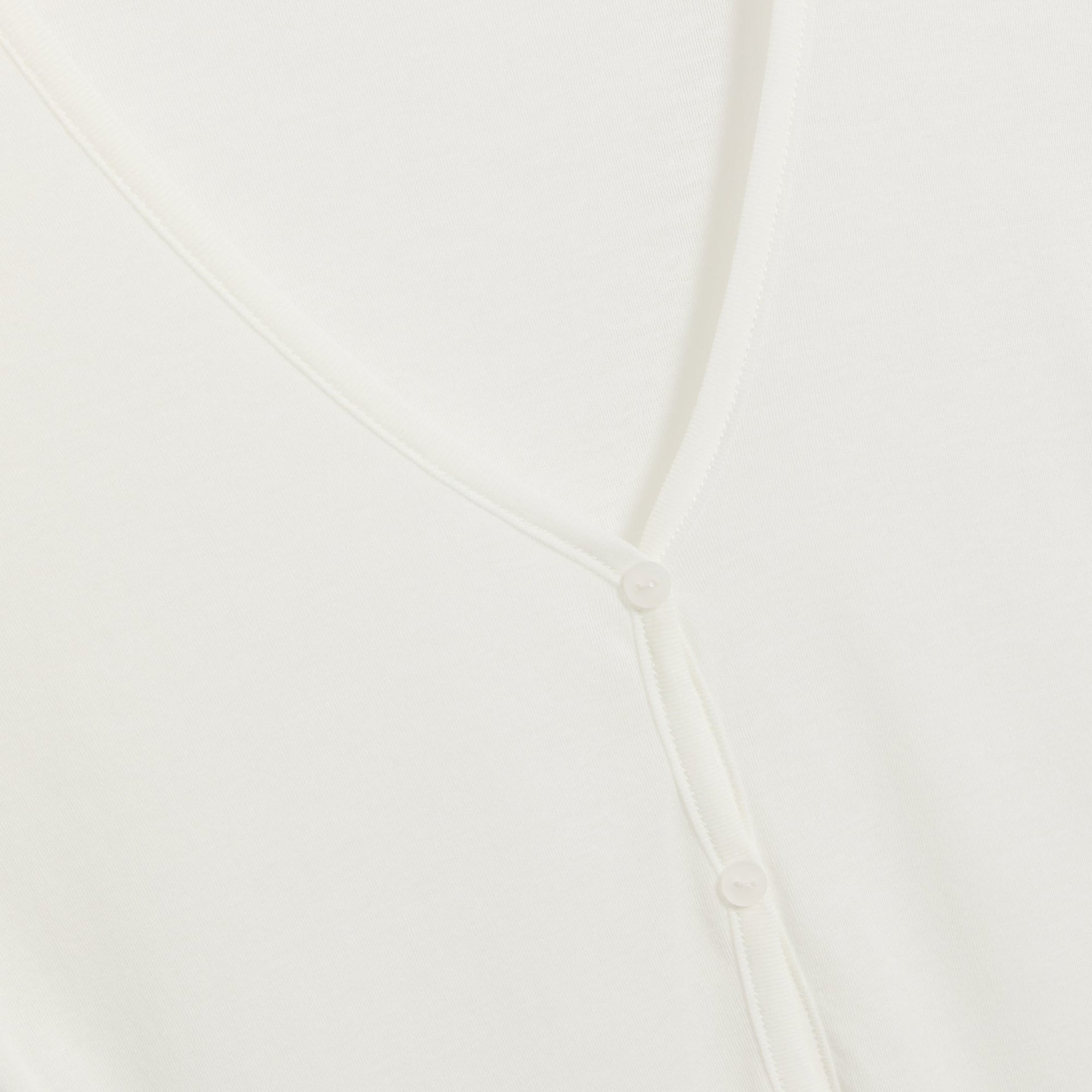 Bond-Eye Elias coconut ivory dress detail, close-up of V-neck buttons and placket