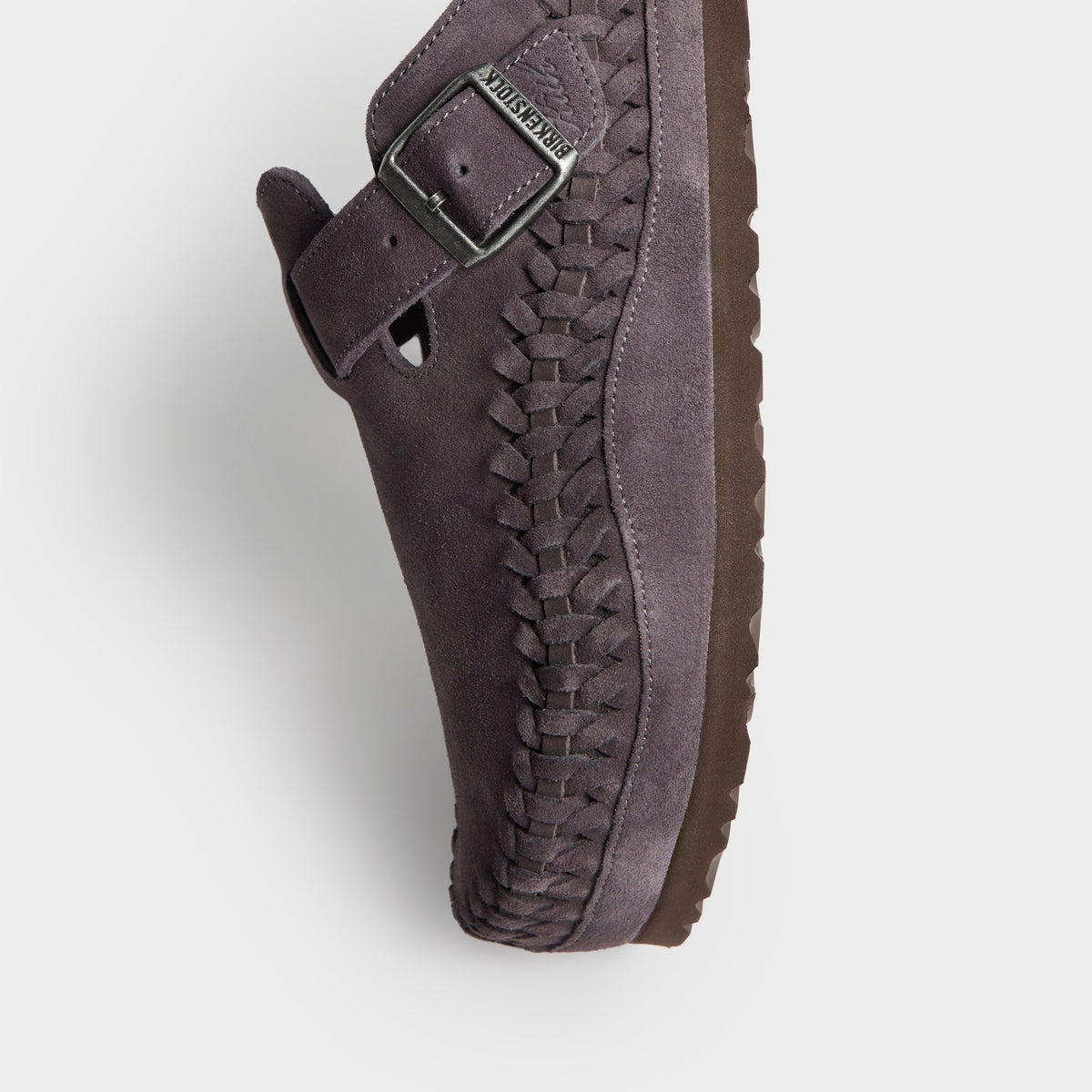 Kith for Birkenstock Boston Braided in Rabbit Grey, angled close-up of the buckle strap, braided edge and brown sole