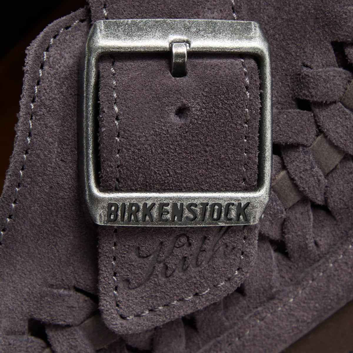 Kith for Birkenstock Boston Braided in Rabbit Grey, macro of the silver buckle embossed Birkenstock with Kith script in charcoal suede