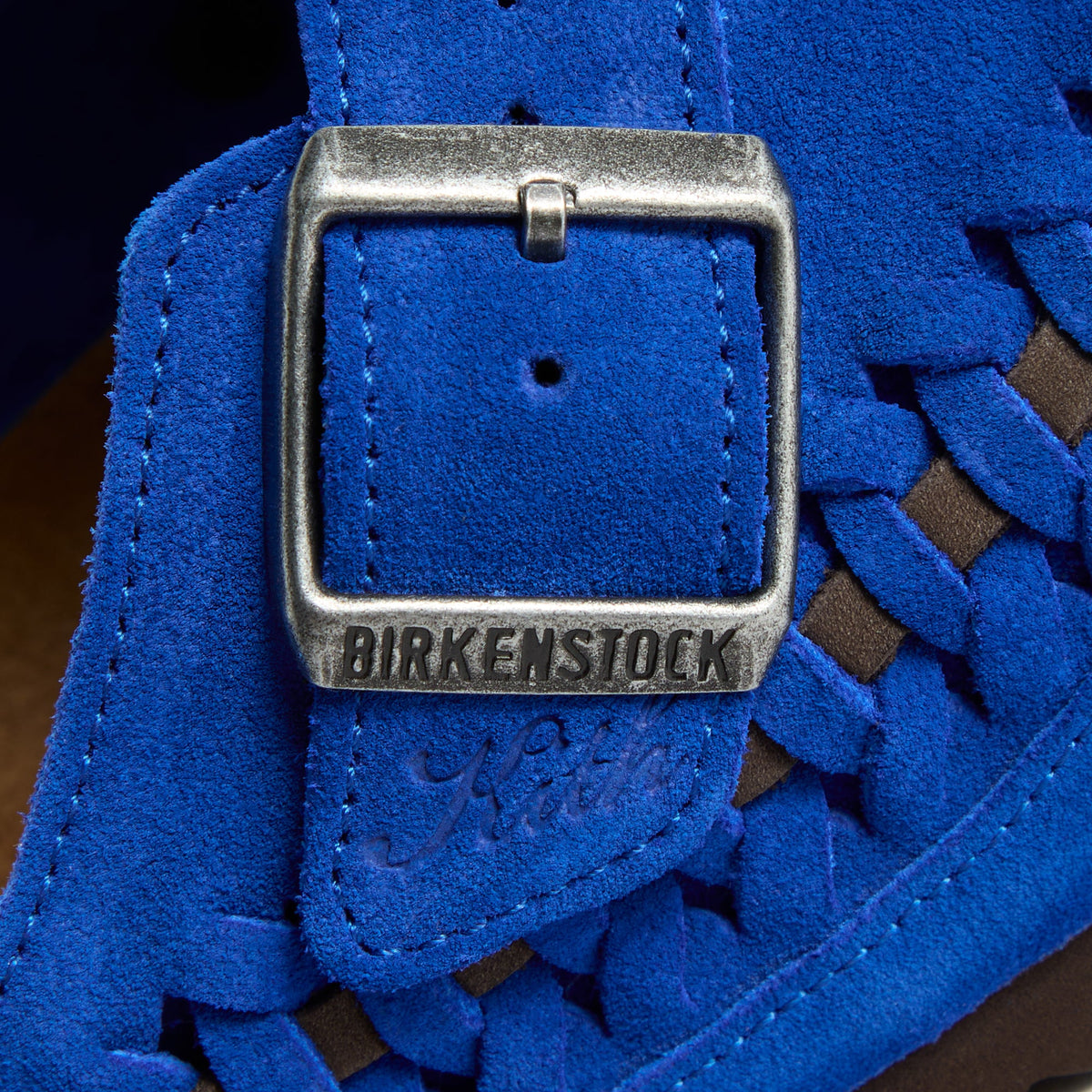 Kith for Birkenstock Boston Braided in Ultra Blue, macro of the silver buckle embossed Birkenstock with Kith script in cobalt suede