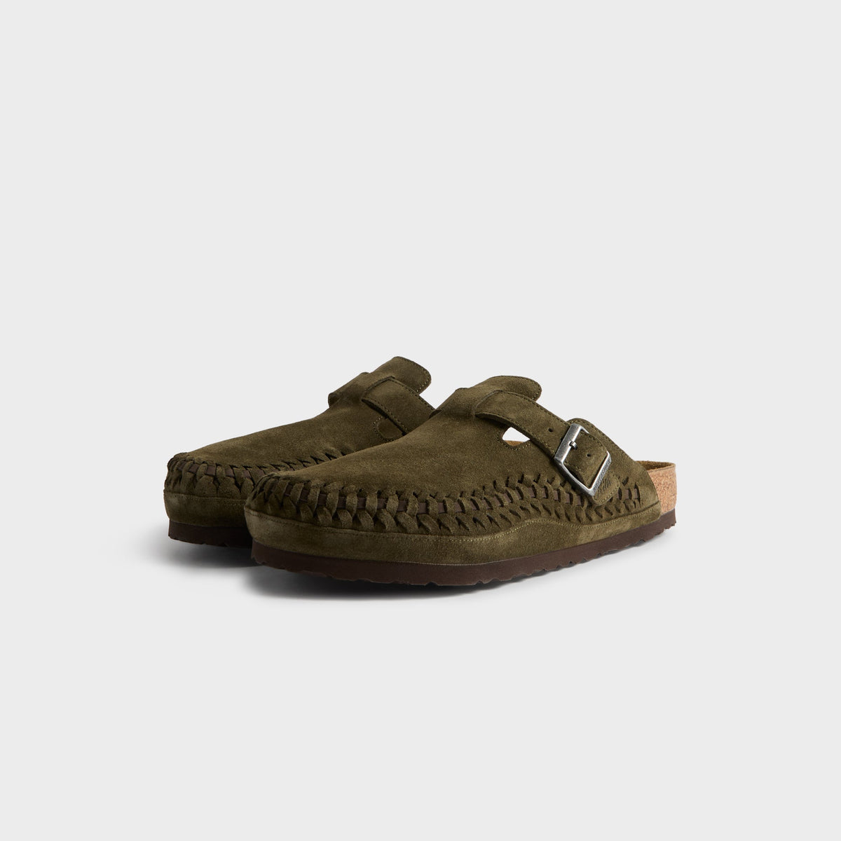 Kith for Birkenstock Boston Braided in Thyme, front three-quarter view of the olive suede clog pair with braided toe edges