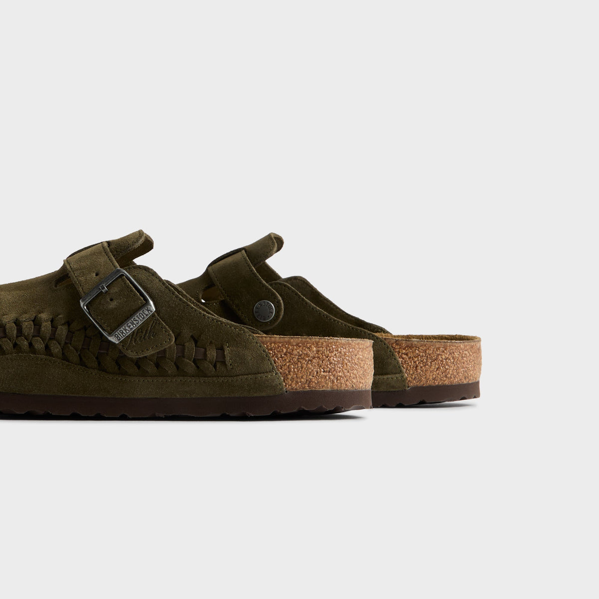 Kith for Birkenstock Boston Braided in Thyme, close-up of the pair's cork footbeds and heels with buckle straps