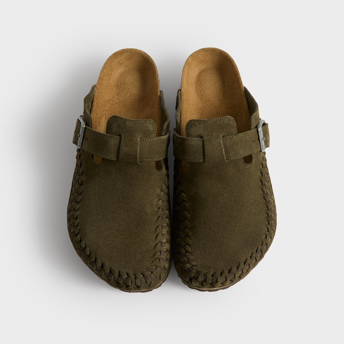 Kith for Birkenstock Boston Braided in Thyme, top-down view of the olive pair showing suede uppers, buckles and cork footbeds