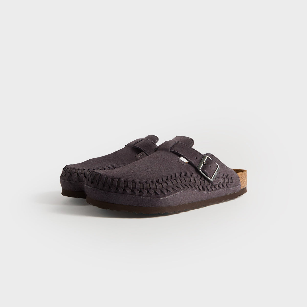 Kith for Birkenstock Boston Braided in Rabbit Grey, front three-quarter view of the grey suede clog pair with braided toe edges