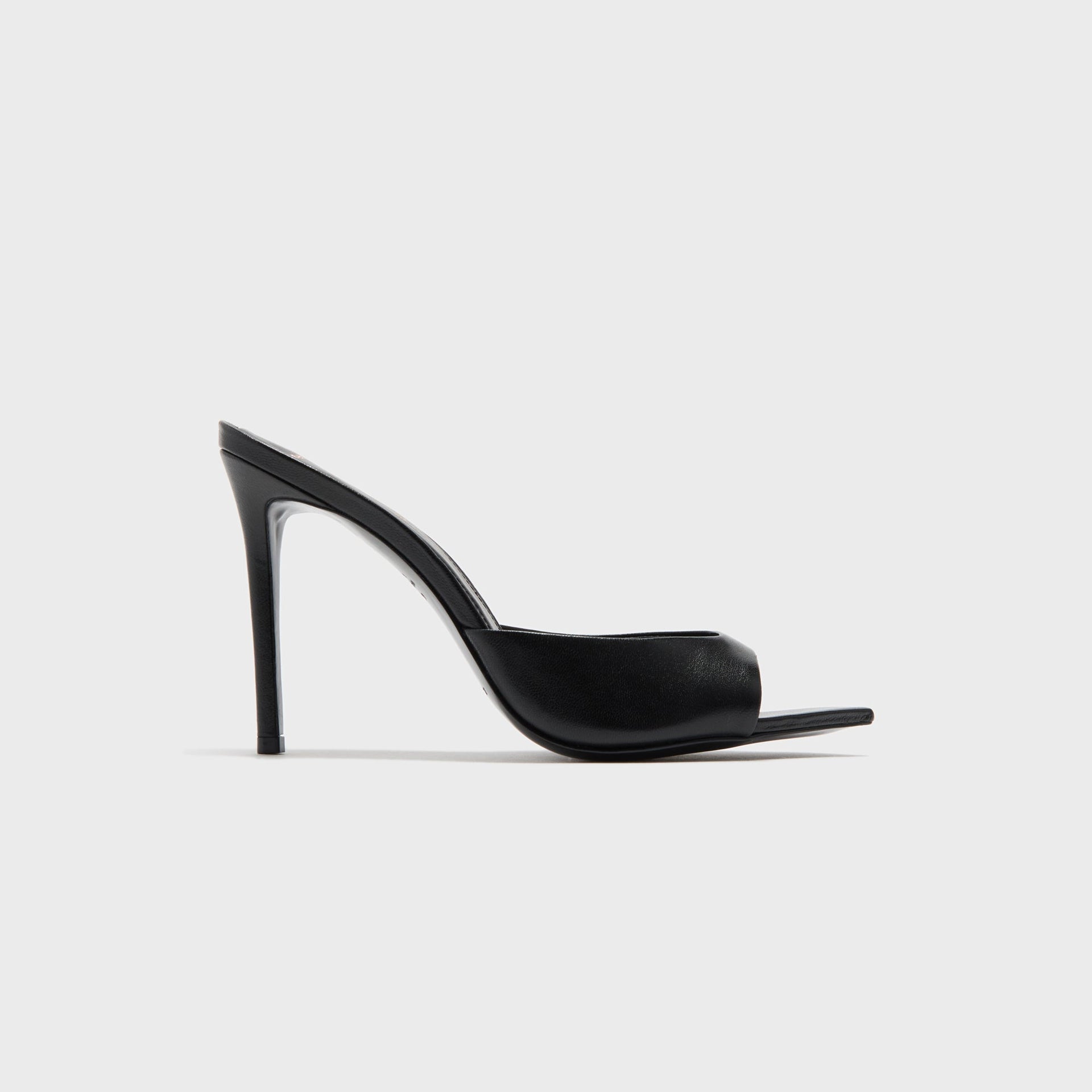 Black Suede Studio Brea heeled mule in black leather, side profile with pointed open toe and stiletto heel