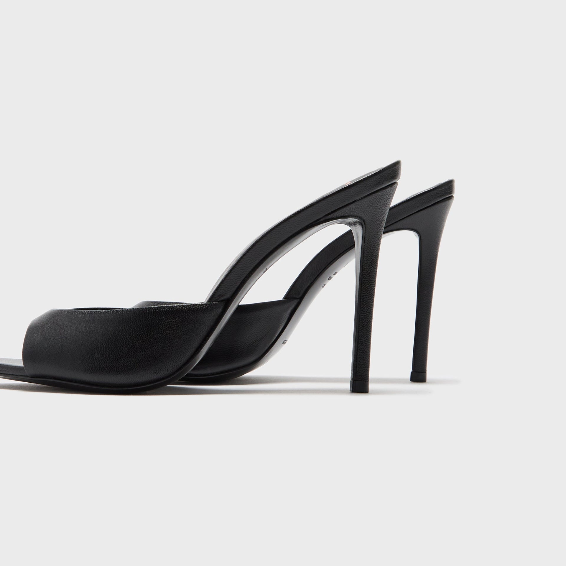 Black Suede Studio Brea heeled mule in black leather, close-up of arch and stiletto heel