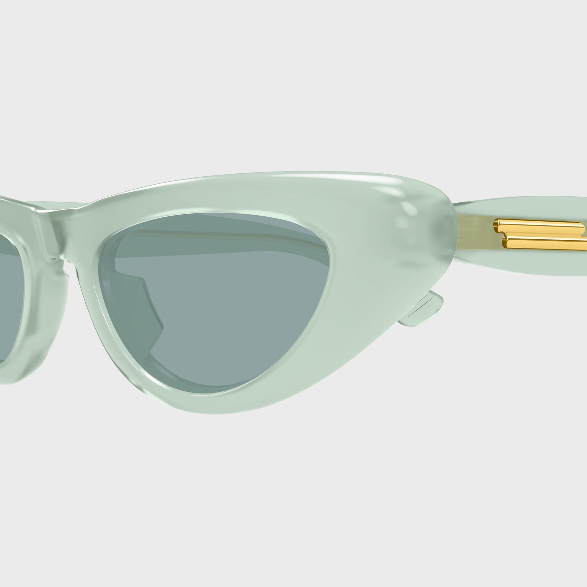 Bottega Veneta Bombe cat-eye sunglasses, close-up of mint green frame and gold temple hardware