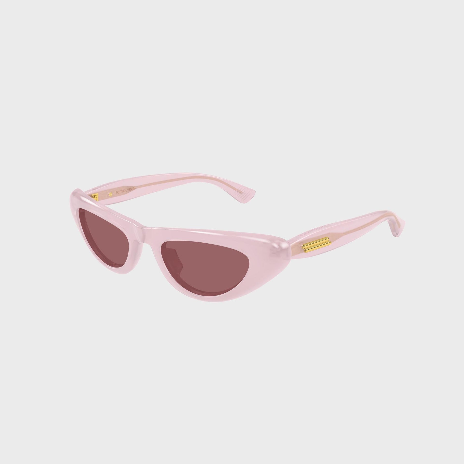 Bottega Veneta Bombe cat-eye sunglasses in pink, three-quarter angle showing gold hinge and temple arm