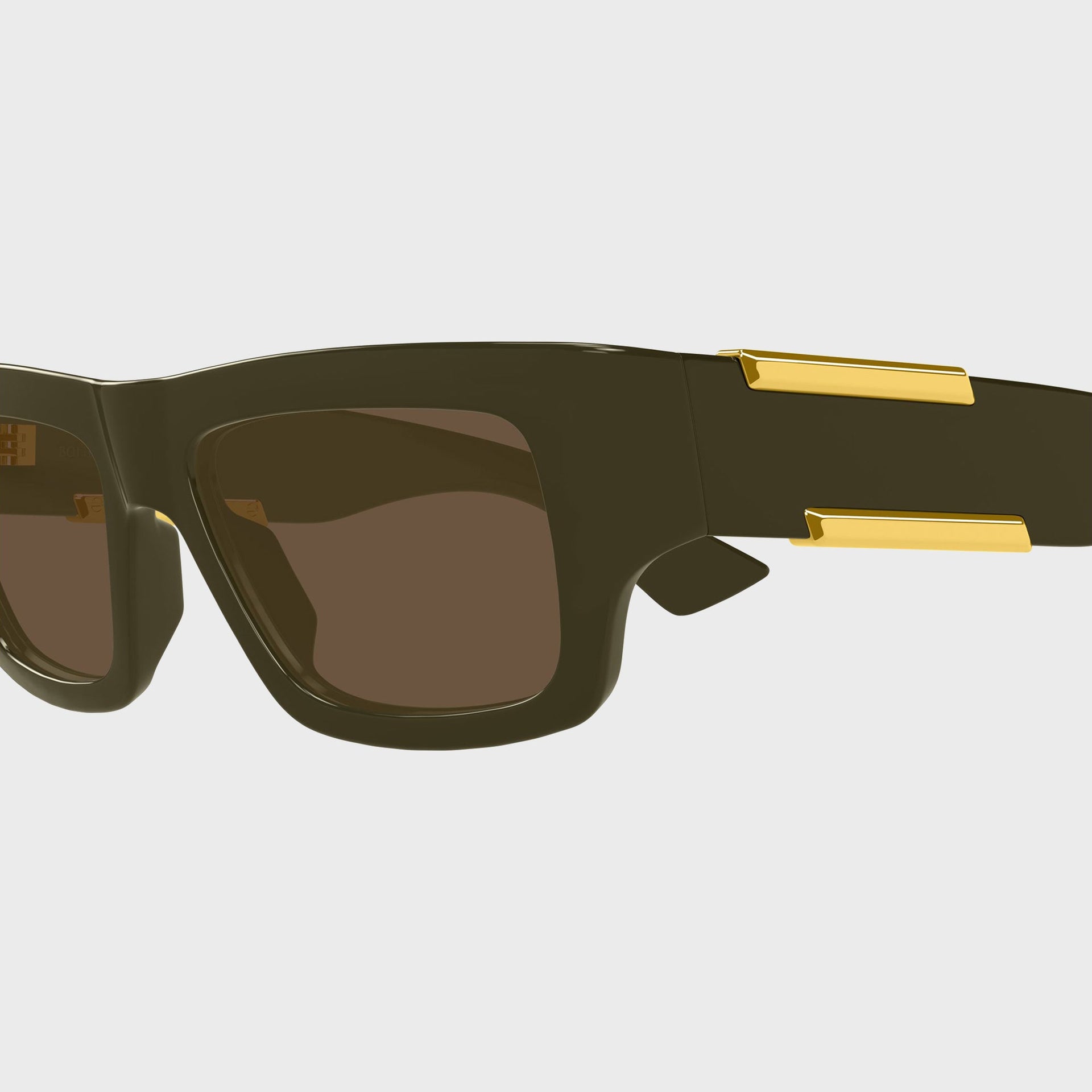 Bottega Veneta Dash squared sunglasses, close-up of olive frame, brown lens and gold temple bars
