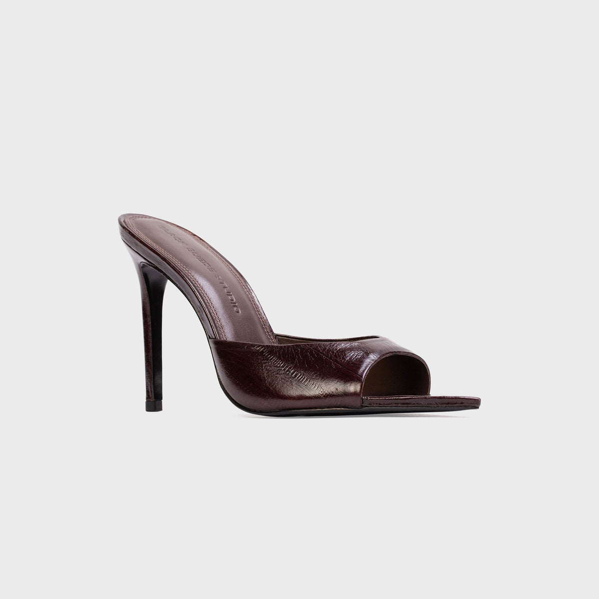 Black Suede Studio Brea Mule in Brown Eel (dark brown embossed leather), three-quarter view with stiletto heel and open toe