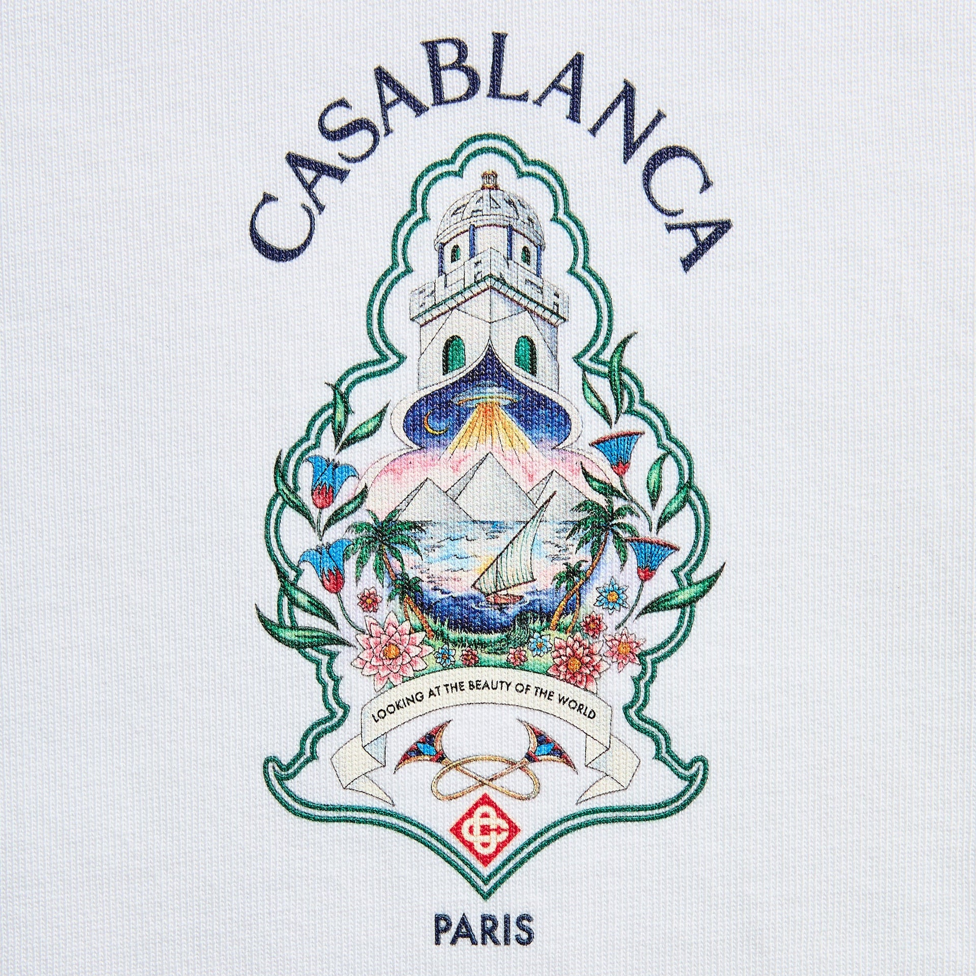 Close-up of Hotel Emblem graphic on white: lighthouse over island with palms, sailboat and pyramids, Looking at the Beauty of the World banner