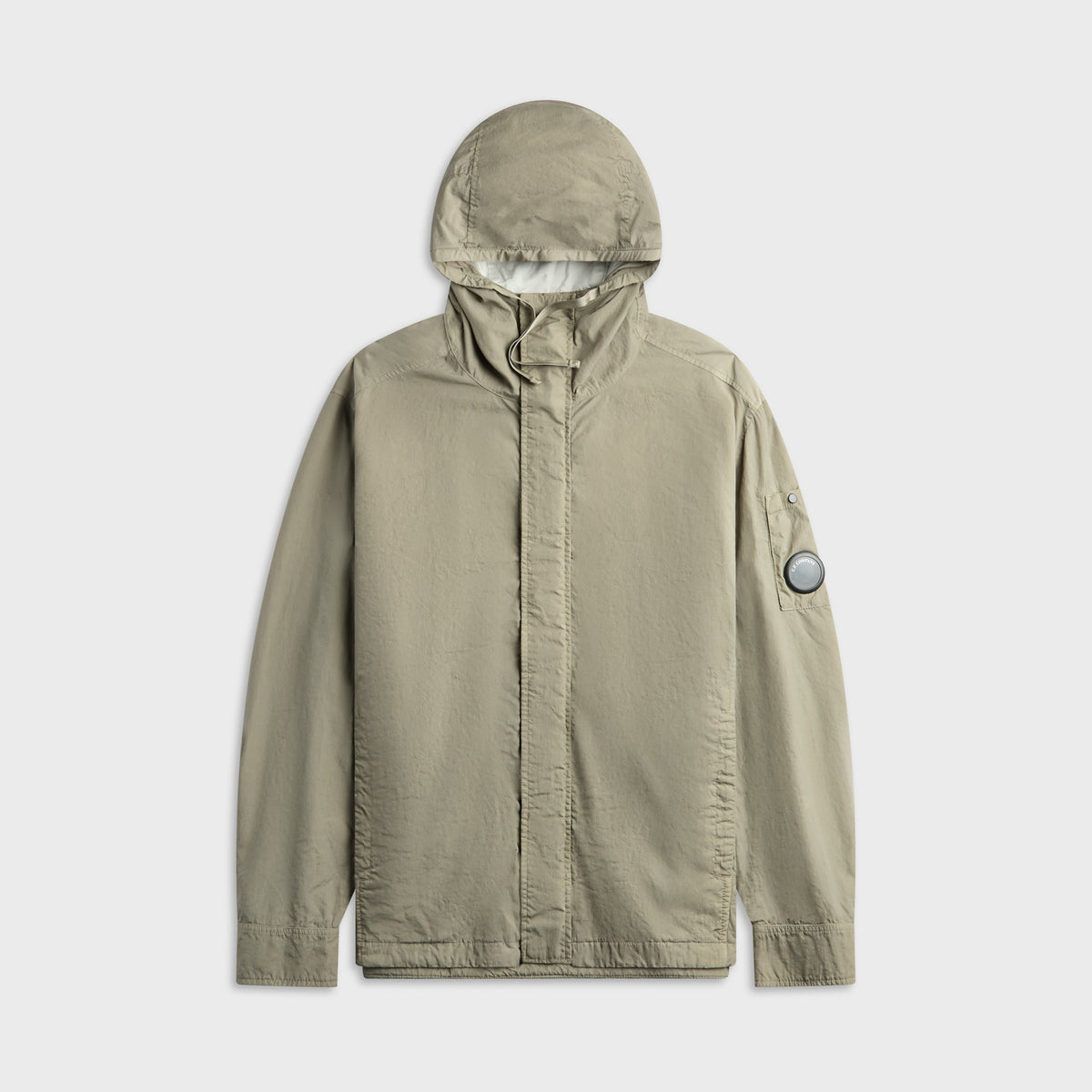 C.P. Company T-ST Nylon Lens Hooded Overshirt in Fallen Rock, khaki hooded overshirt with lens detail on sleeve, front view