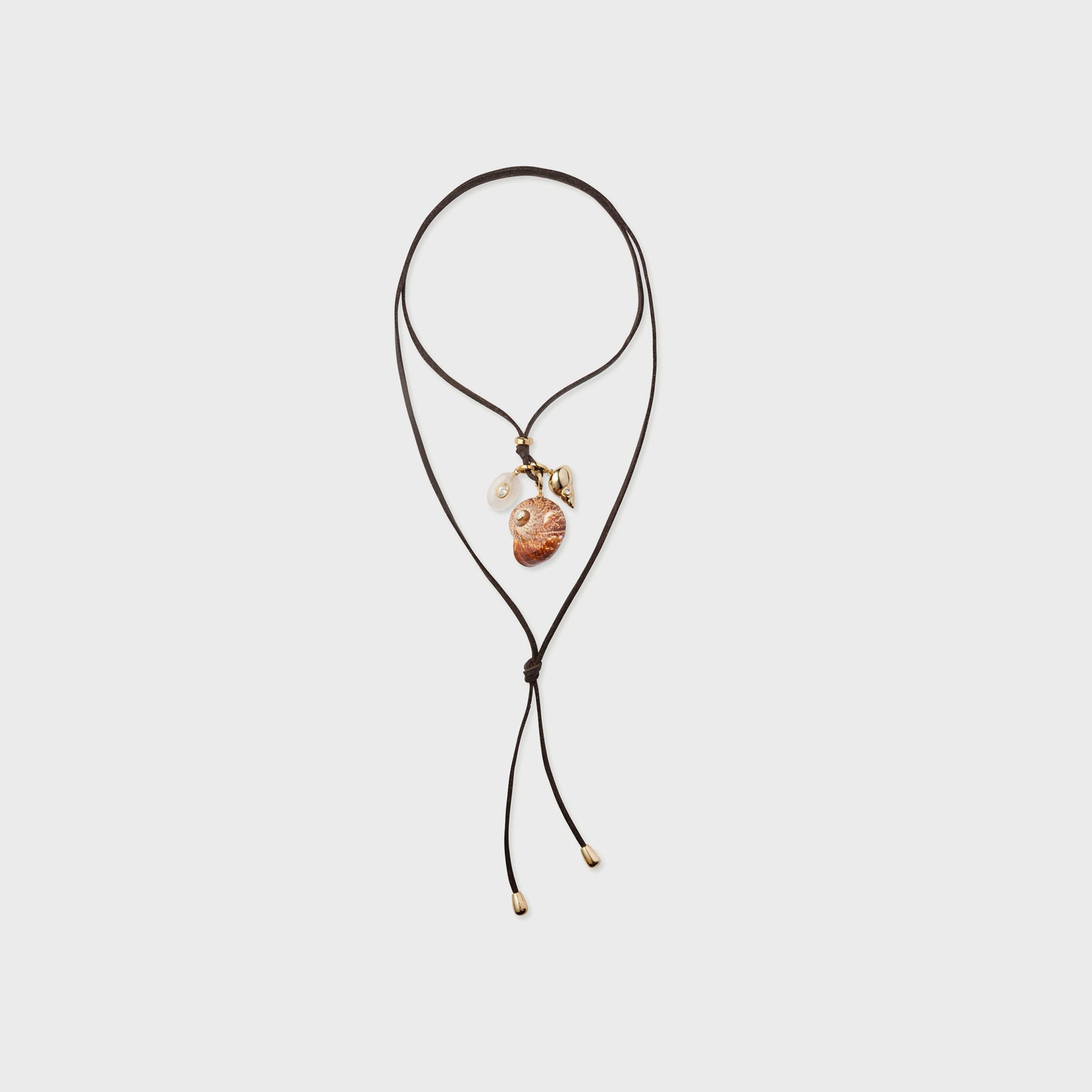 Eliou Area charm wrap necklace, brown leather cord with seashell, pearl and gold bead charms and adjustable ties