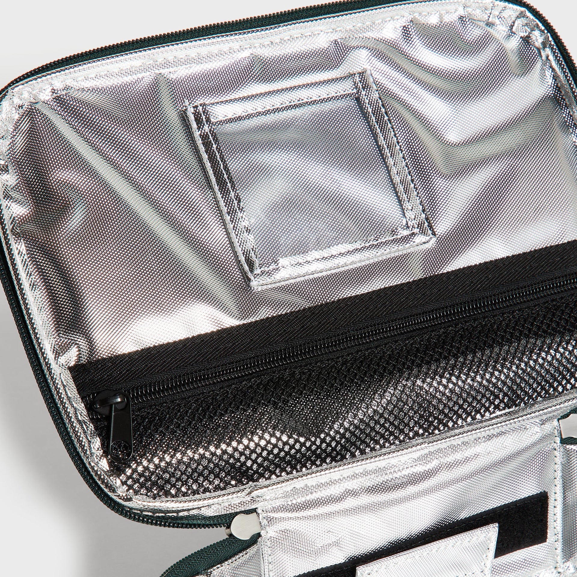 Kith Kids for STATE Rodgers Lunch Box interior close-up of silver insulated lining and zip mesh pocket