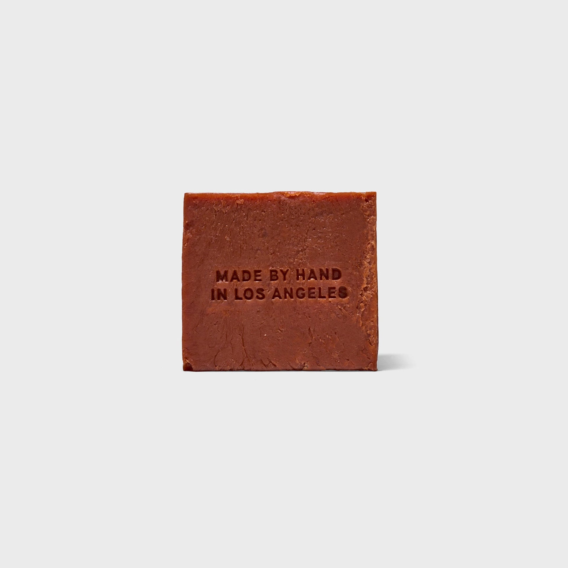 Flamingo Estate Heirloom Tomato soap brick, back of red-brown bar embossed Made by Hand in Los Angeles