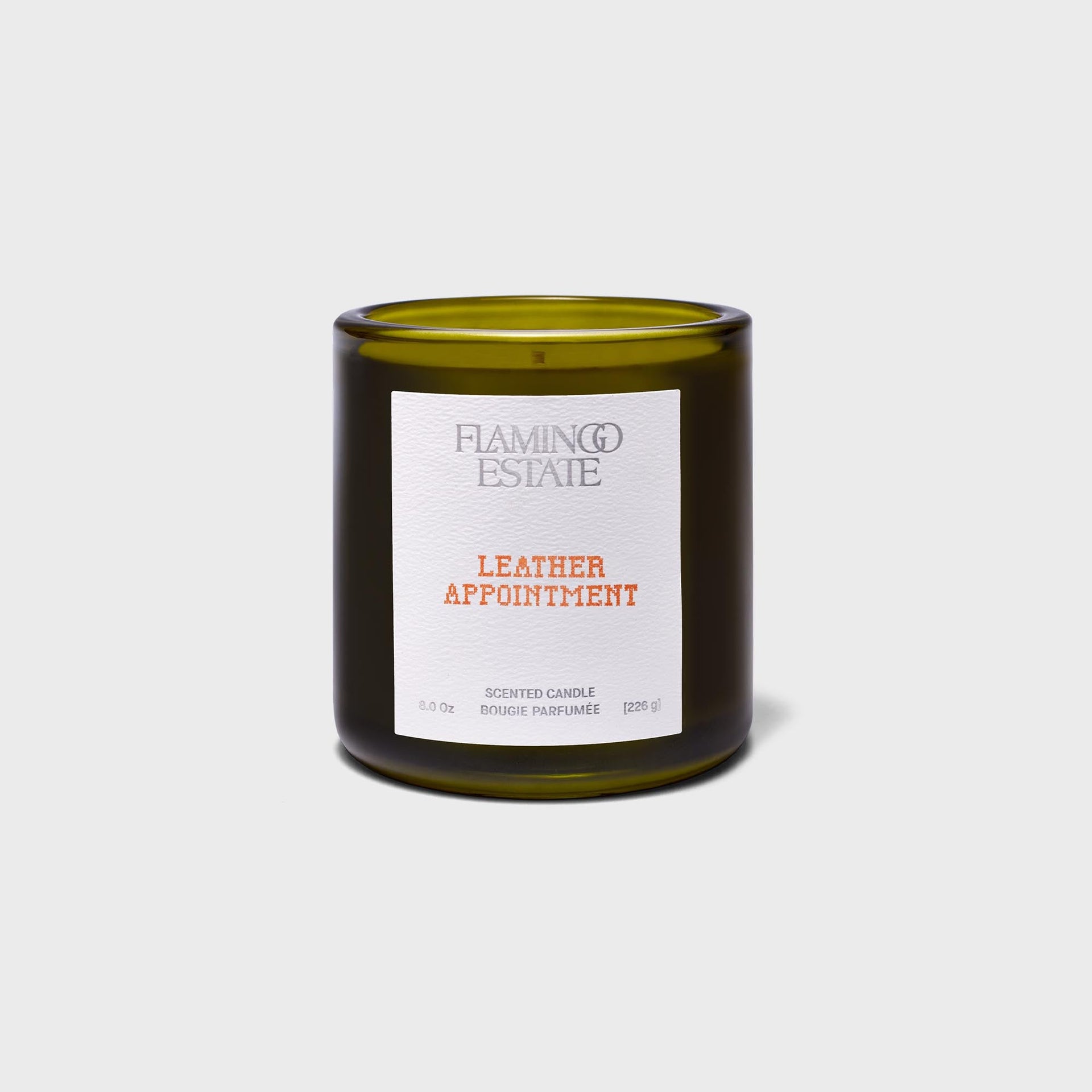Flamingo Estate Leather Appointment scented candle, olive-green glass jar with white letterpress label, 226g