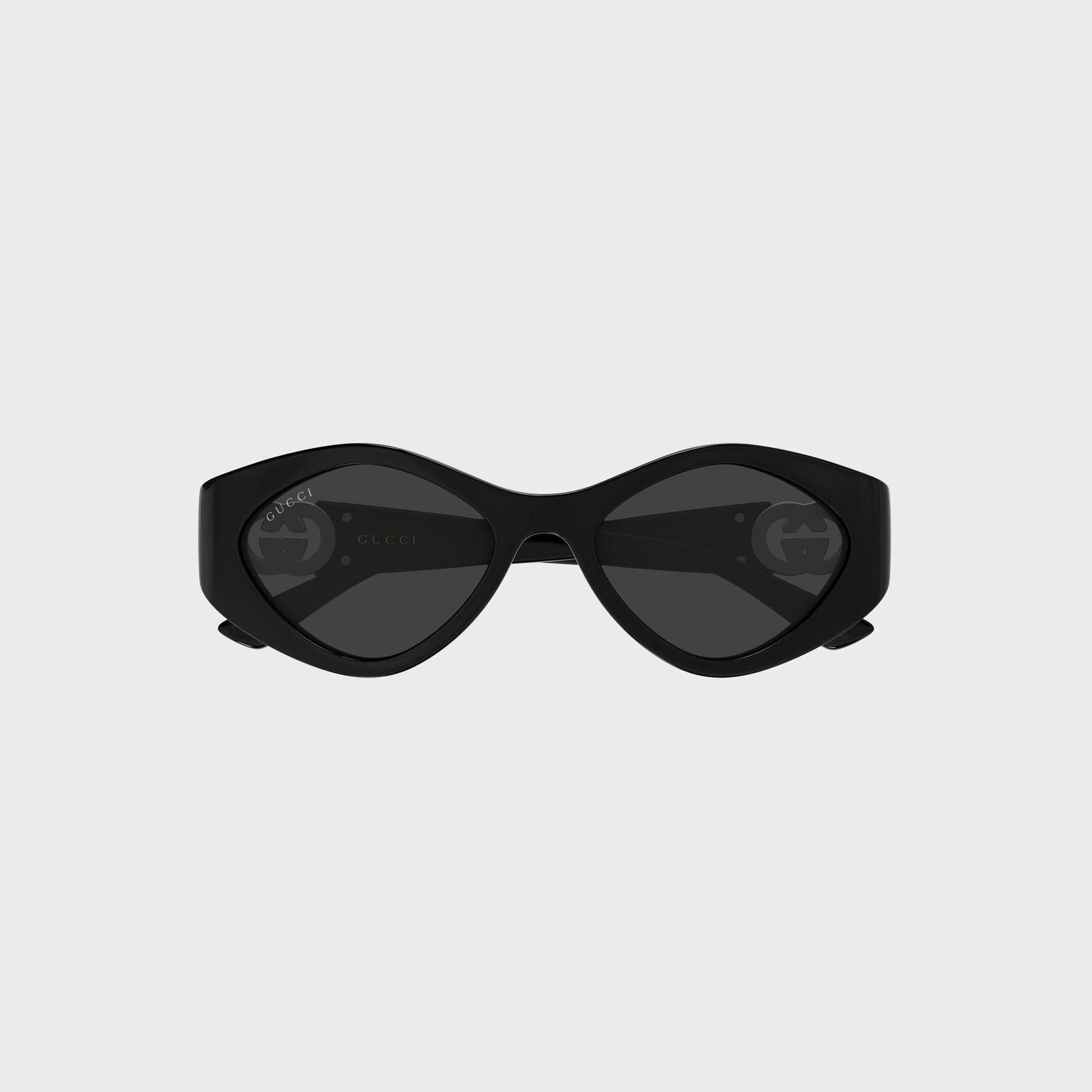 Gucci Interlocking G sunglasses, front view, black frame, grey lenses with GG logos, GUCCI on temple