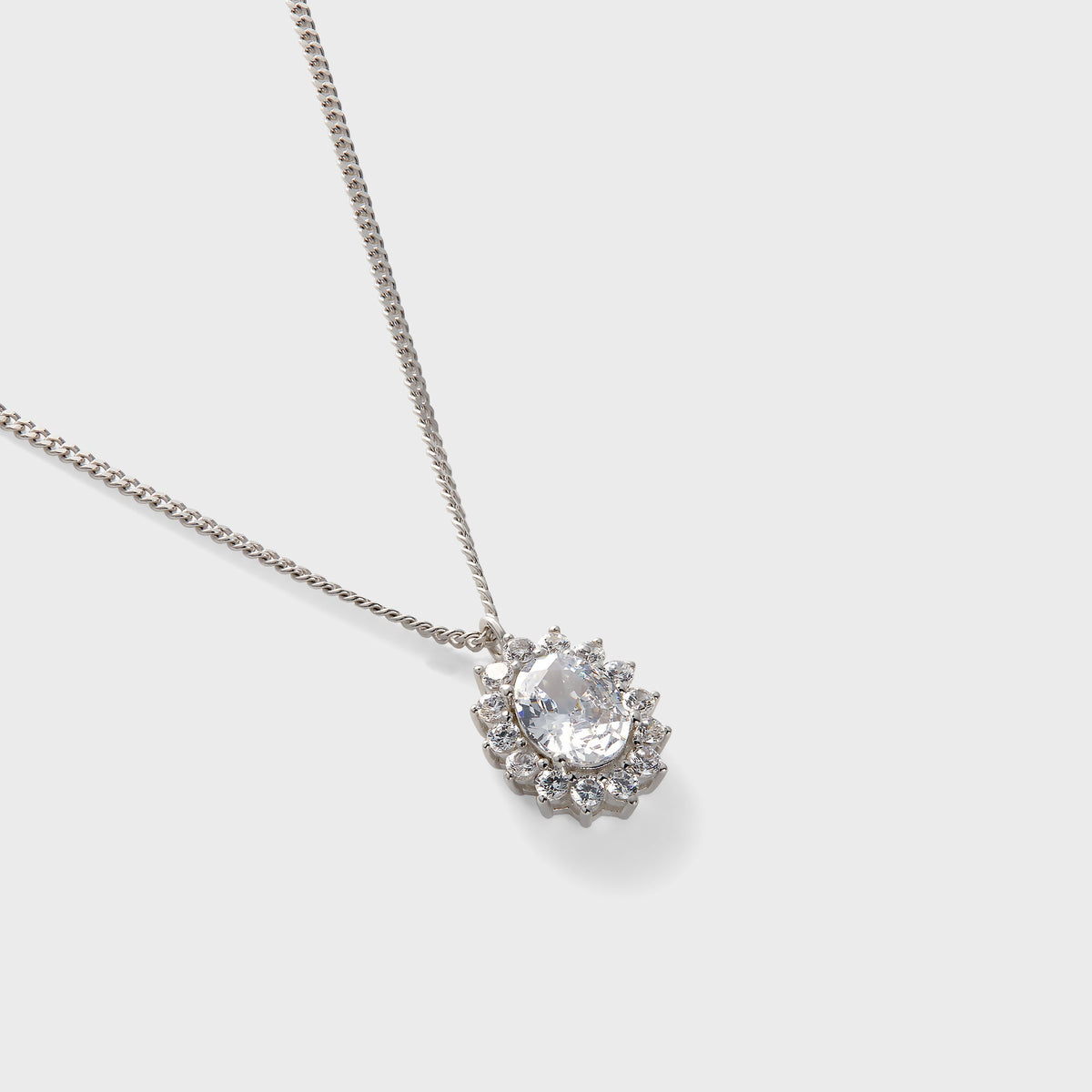 Hatton Labs Crown Stone Pendant Necklace in white, close-up of clear oval stone with round stone halo on curb chain