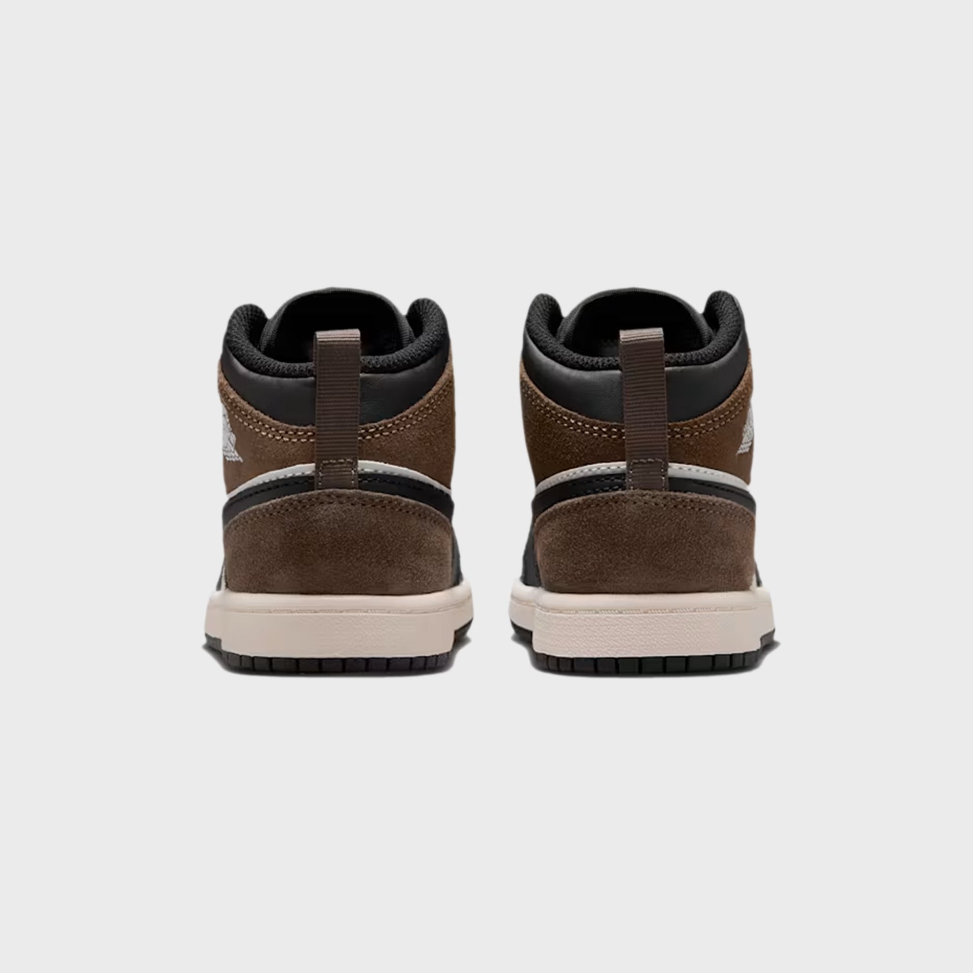 PS Air Jordan 1 Mid heel view with brown suede counters, white Wings logos and sail soles
