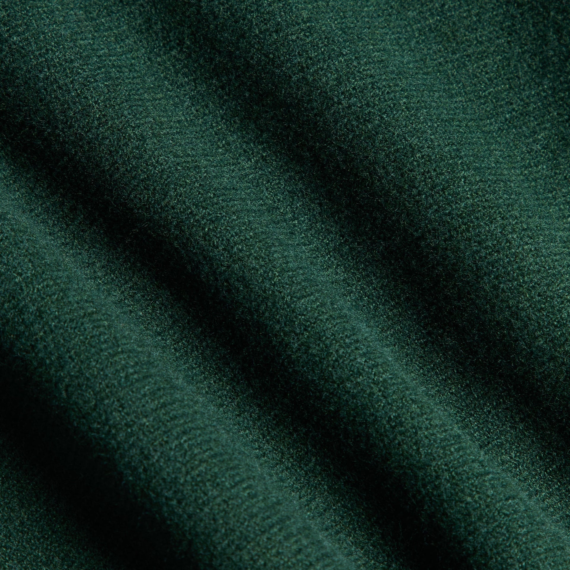 Close-up of the Kith Baby Varsity Jacket's green wool body fabric texture in Stadium colorway