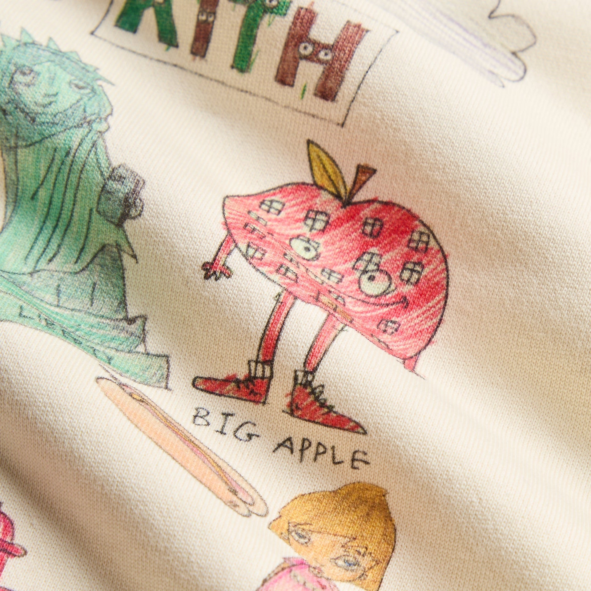 Close-up of the Kith Baby for Matthew Langille Nelson Hoodie's illustrated Big Apple character artwork