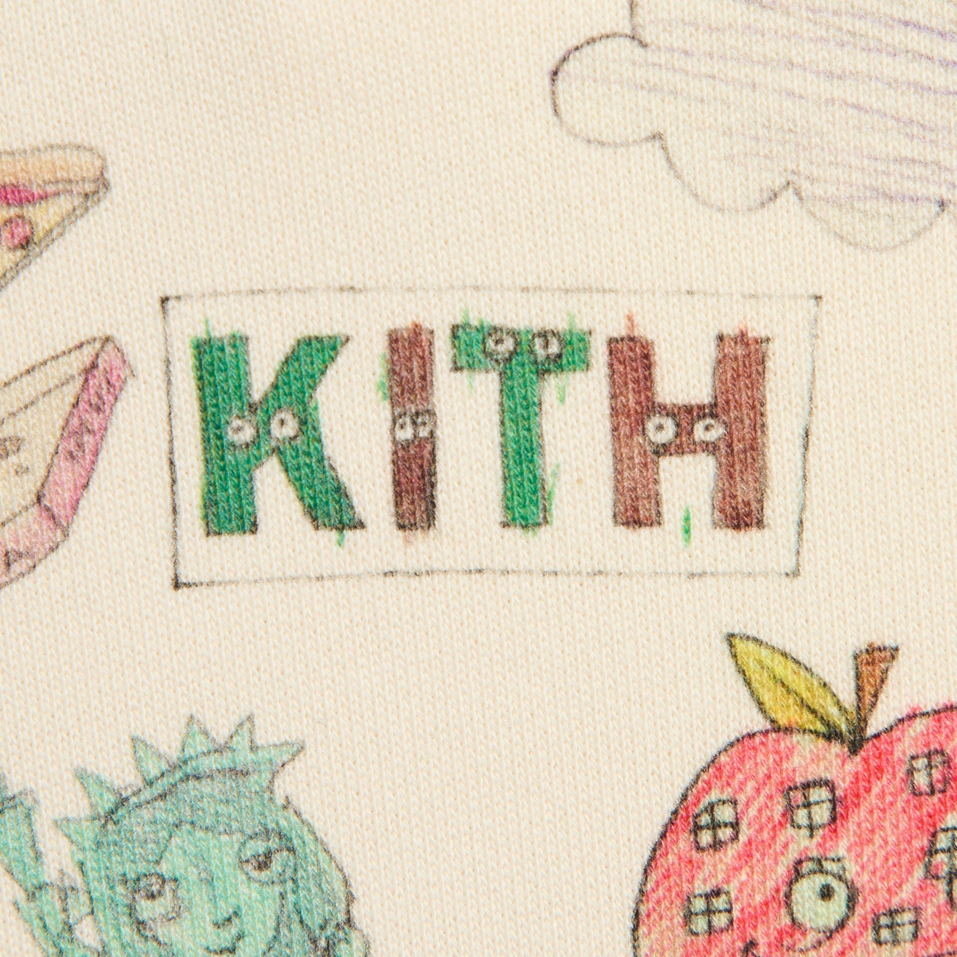 Close-up of the Kith Baby for Matthew Langille Nelson Hoodie's illustrated Kith logo box graphic on cream fleece